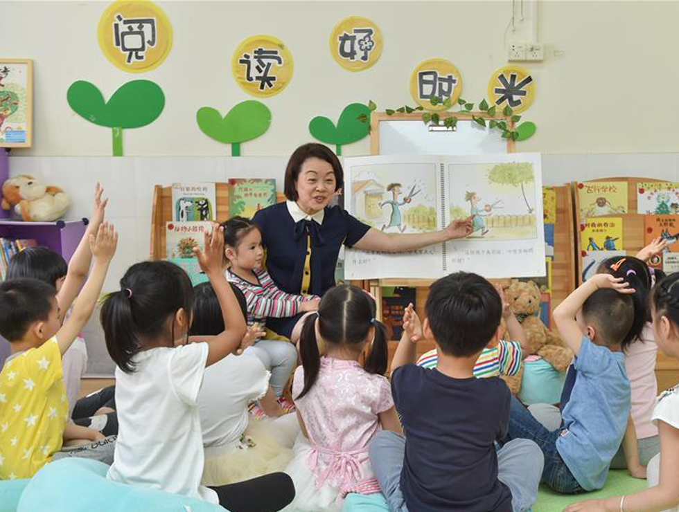 隋玉玲在幼儿园阅览室与孩子们进行阅读分享